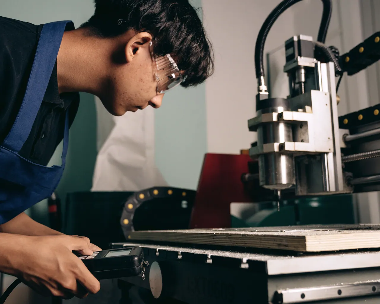 Engineer inspecting work beside an industrial machine